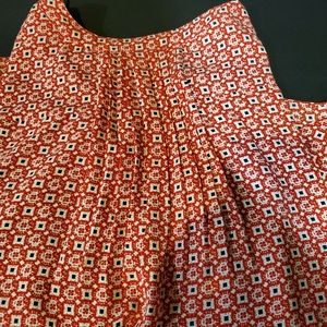 Red patterned sleeveless blouse.